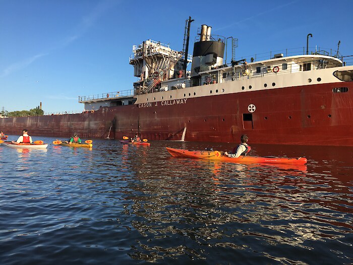 Kayakers paddle past the Cason J. Callaway cargo ship on the Rouge River. Photo credit: Friends of the Rouge River.