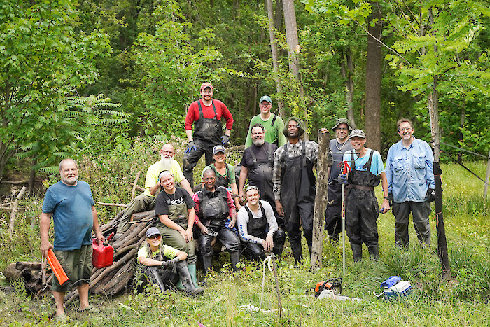 Volunteers work in a forest adjacent to the Rouge River. Photo Credit: Friends of the Rouge River.