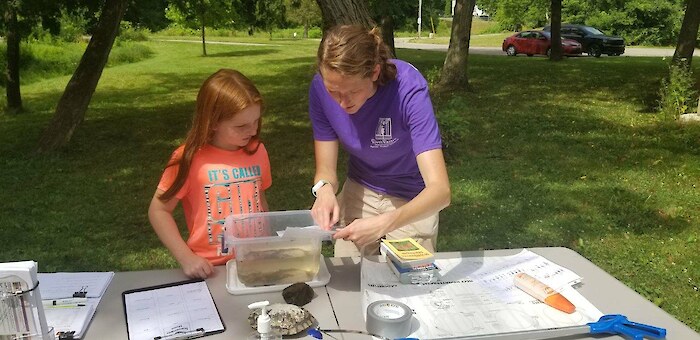 A riverkeeper teaches about water quality monitoring. Photo credit: River Raisin Watershed Council.