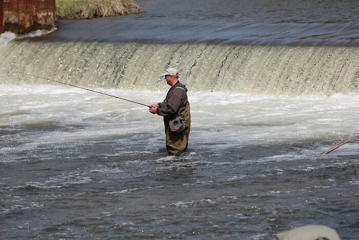 Fisherman patiently waits for a catch in Clinton, Michigan. Photo credit: Clinton River Watershed Council.